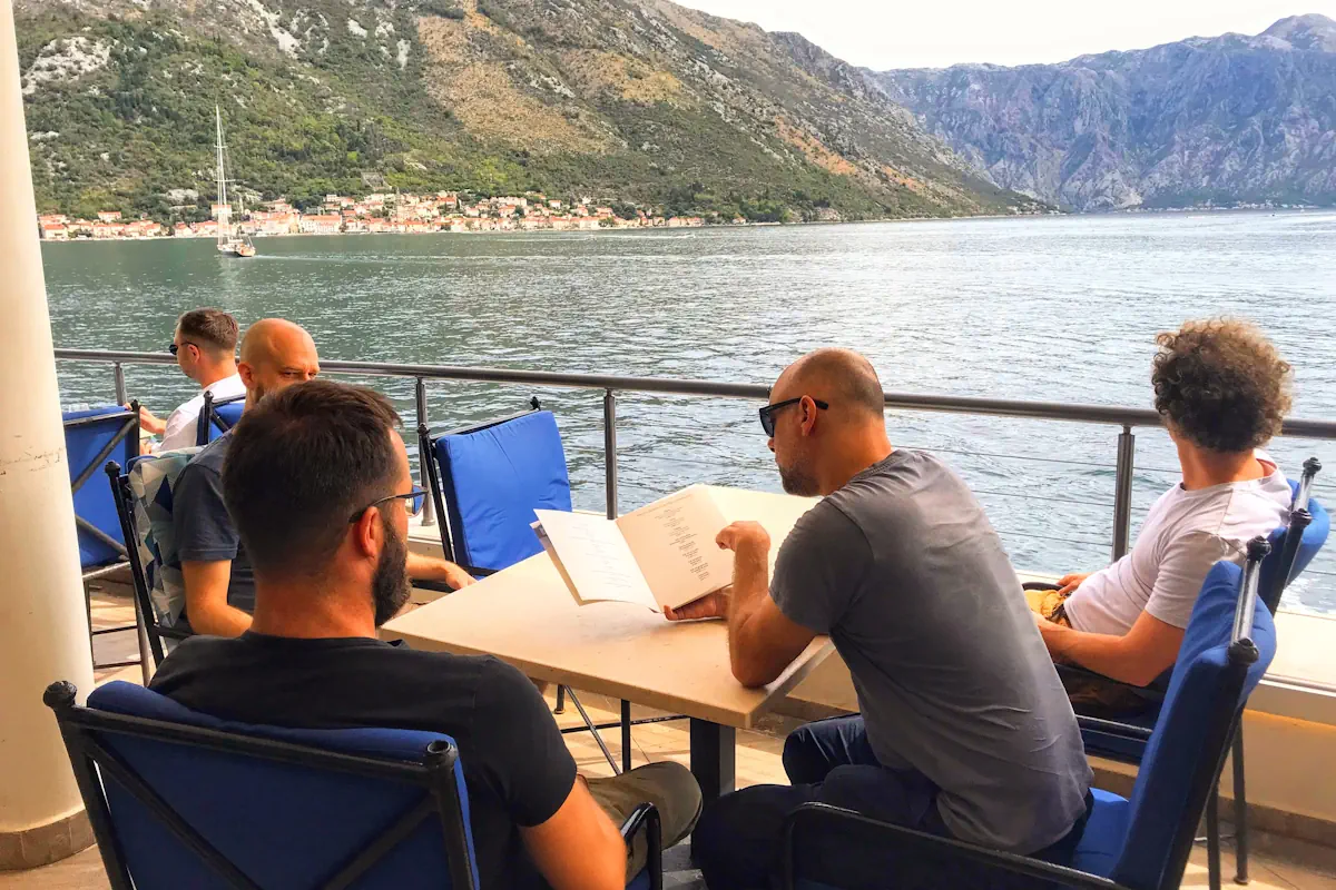 The modern terrace of Verige65 restaurant overlooking the Verige Strait and the Perast islands in the Bay of Kotor.