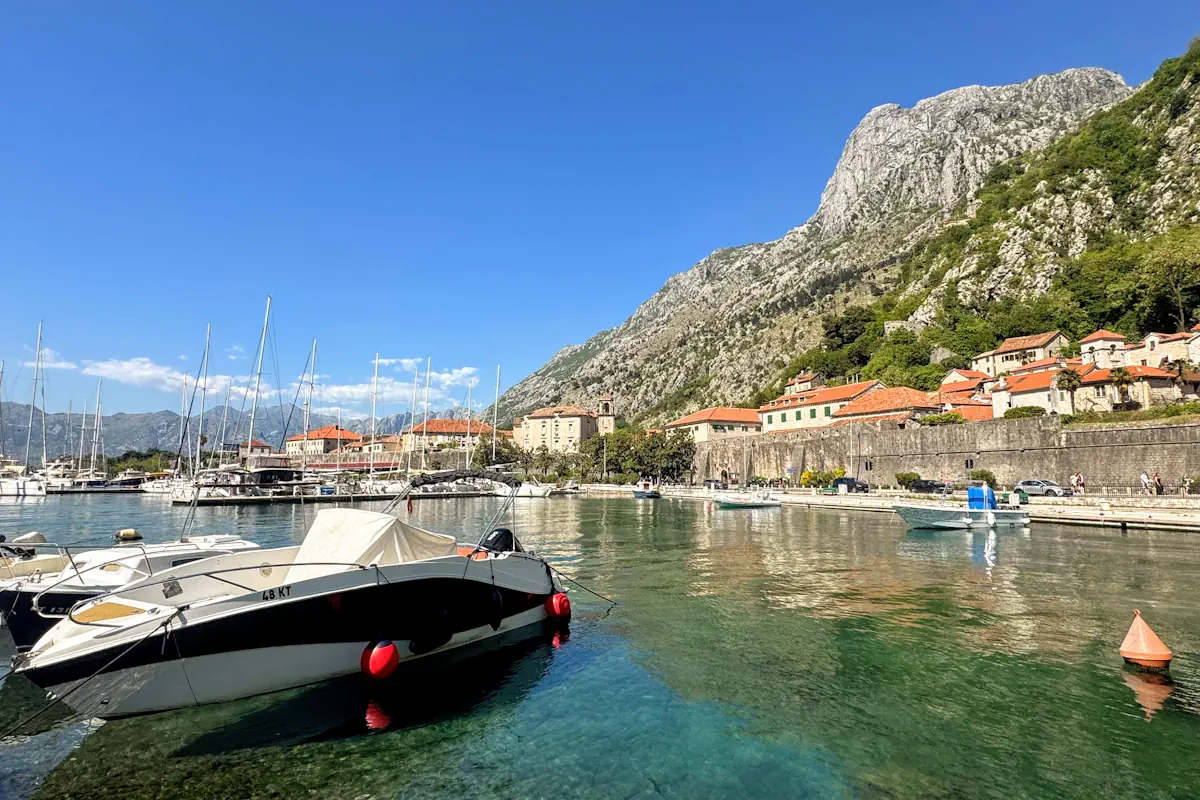 Kotor Old Town Walls with Boats docked in the marina