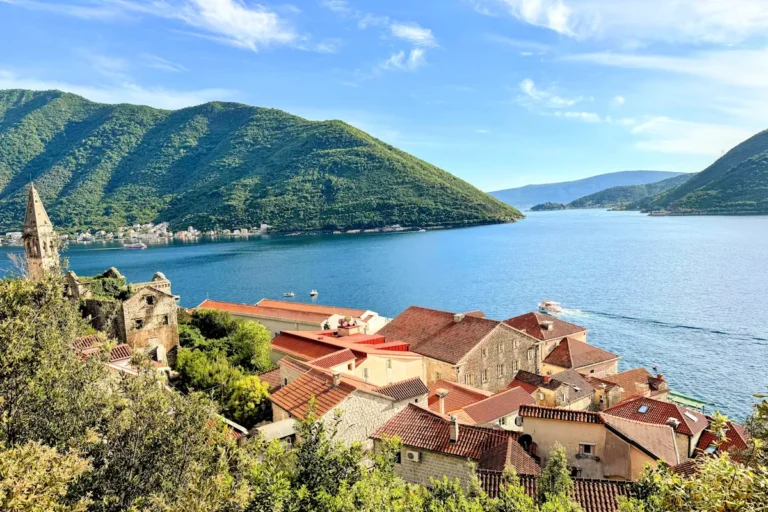 Aerial View of Perast, its red, Mediterranean roof tiles, and the Verige Strait from the upper coastal road