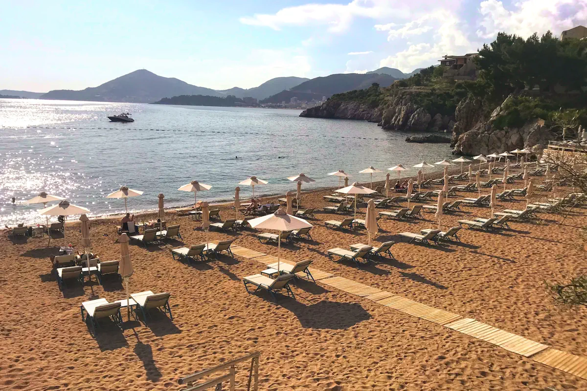 Aerial view of the fishing village and beach of Przno with Hotel Maestral's neatly positioned sun loungers overlooking the bay